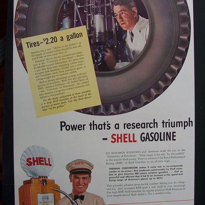 1941 Shell Gasoline with Man Looking Through Tire
