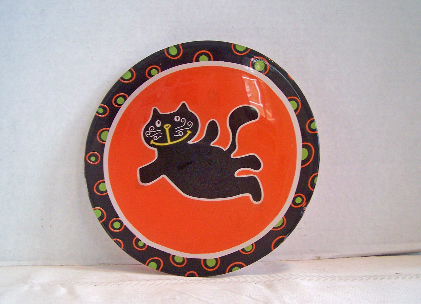 Black Cat on Orange Glass Plate