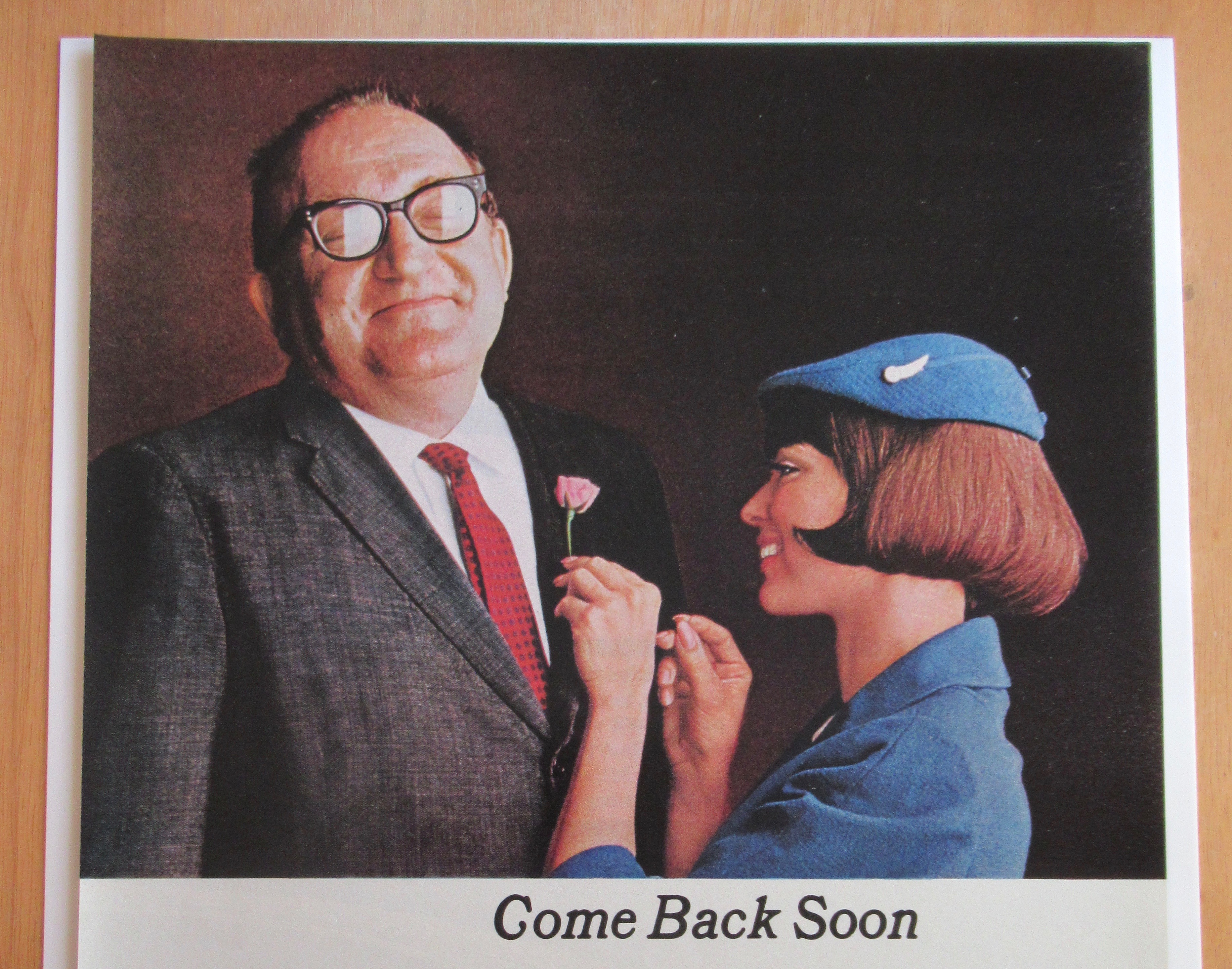 1966 United Airlines w/Stewardess Pinning Flower on Man
