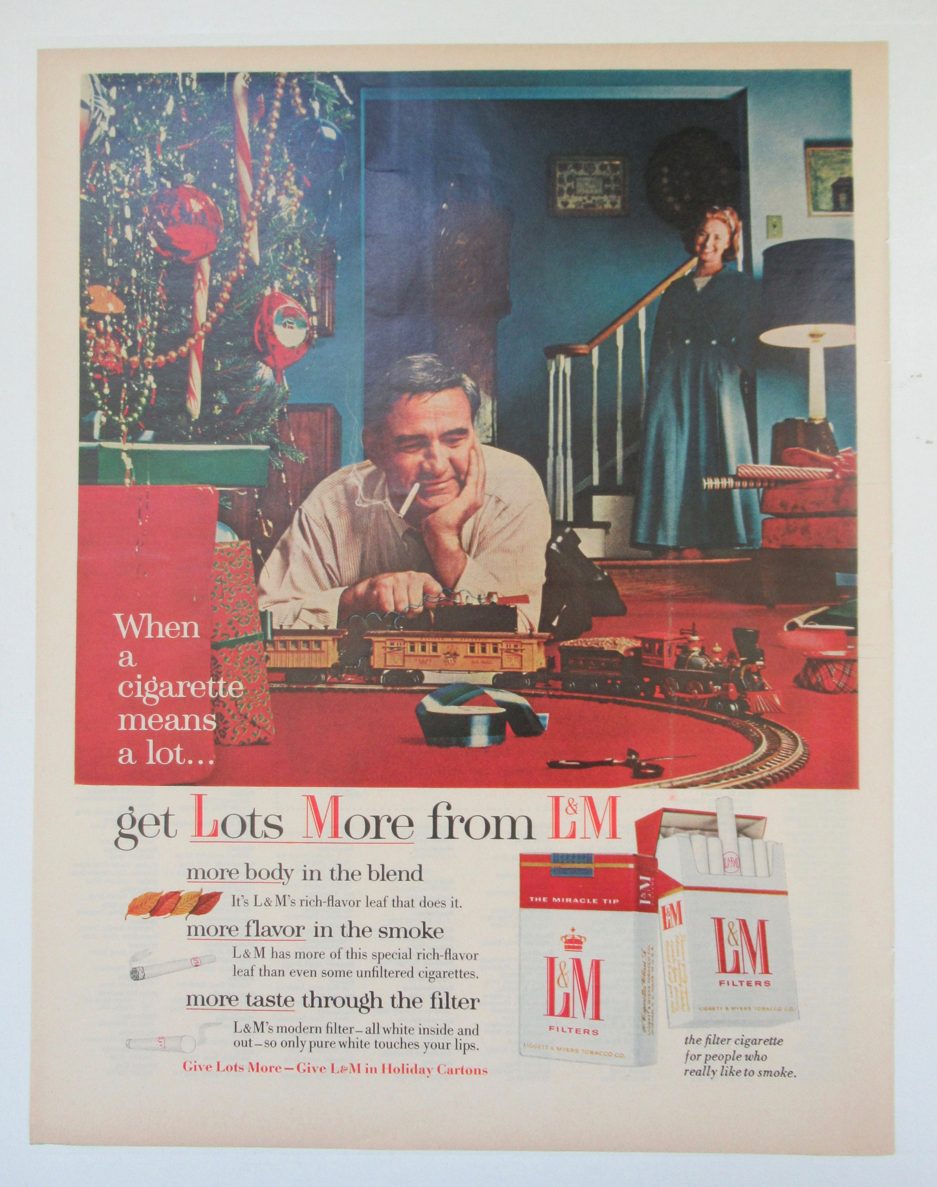 1955 L & M Cigarettes with Man Playing with Train