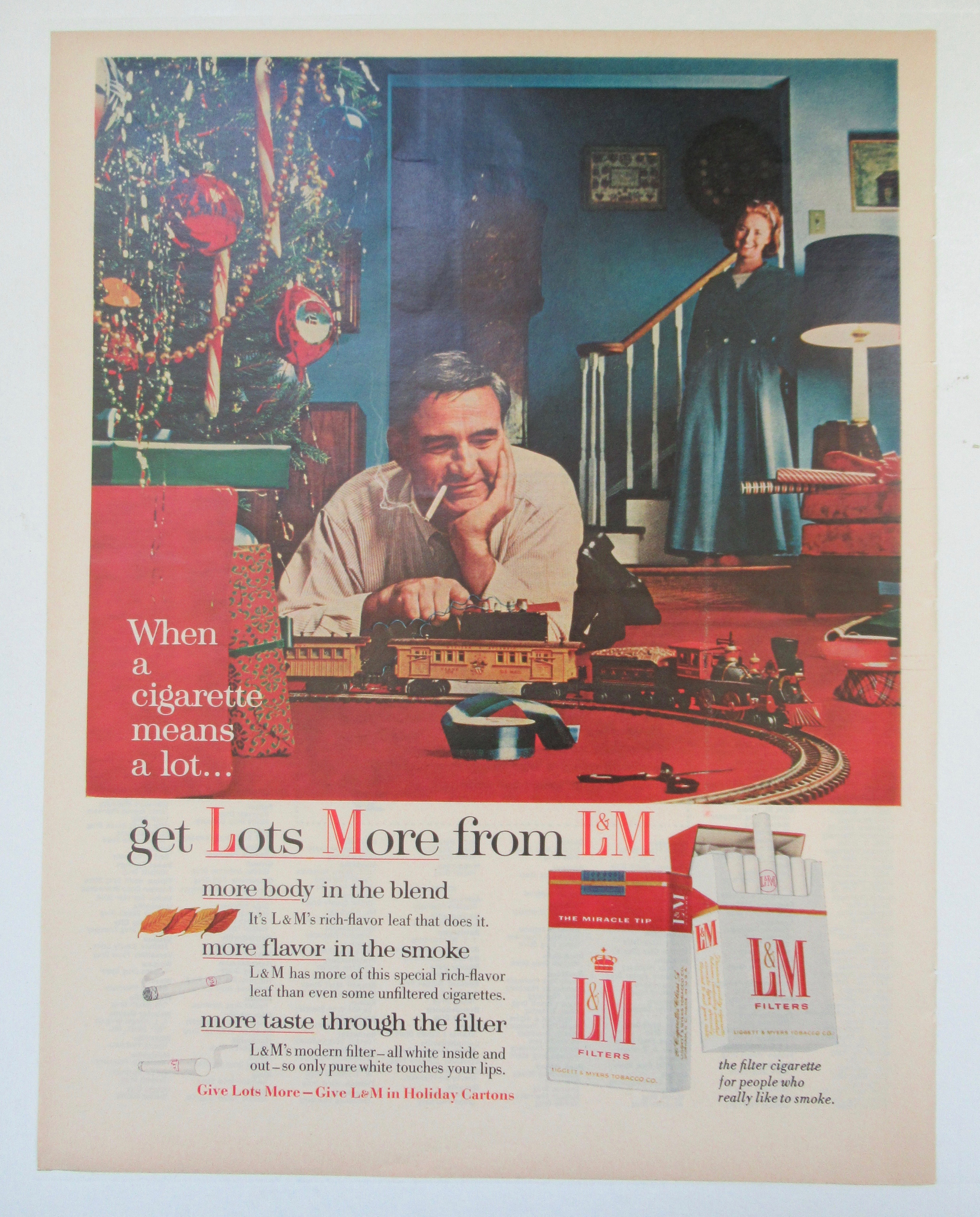 1955 L & M Cigarettes with Man Playing with Train