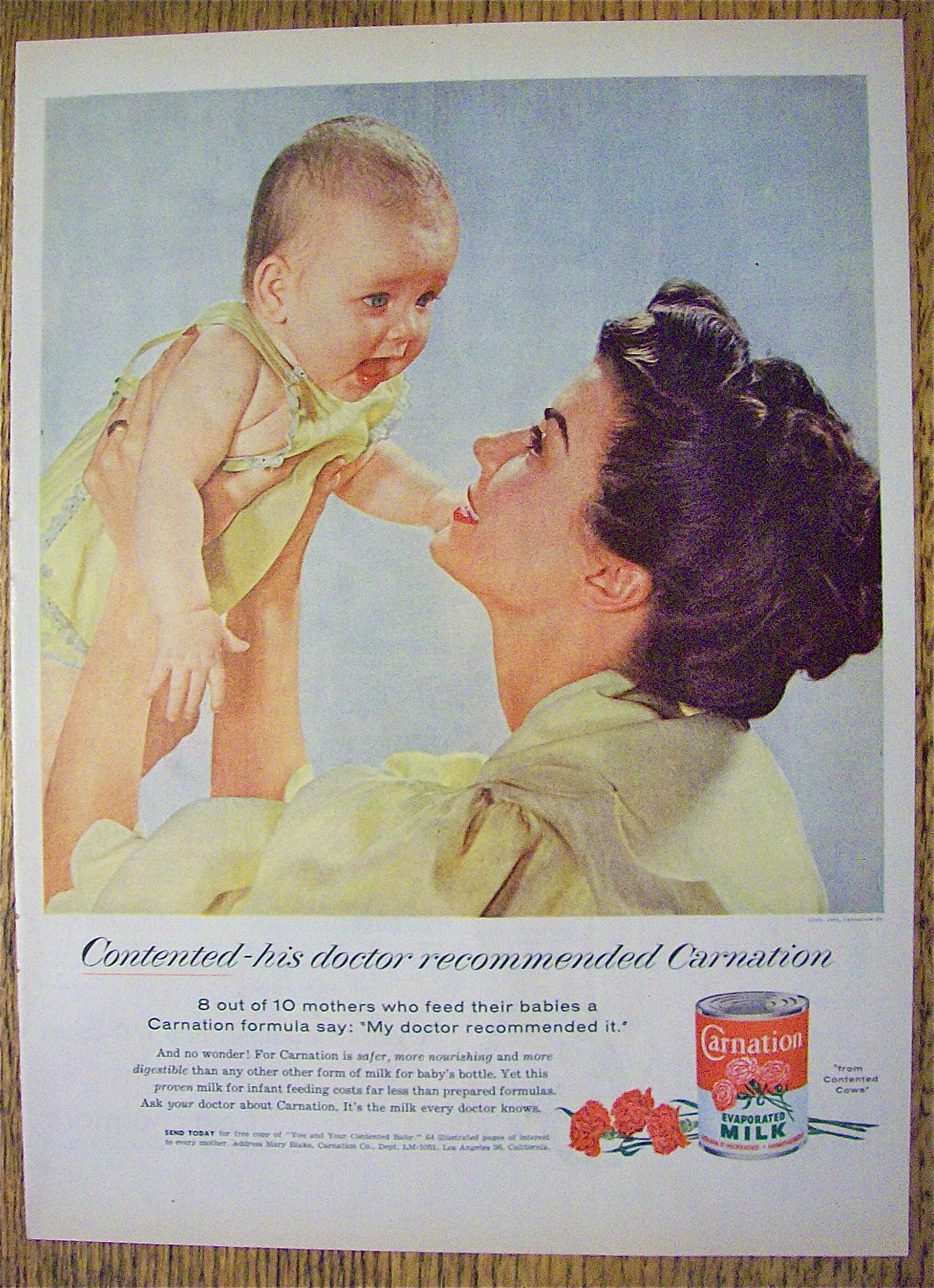 1955 Carnation Milk with Mother Holding Up Baby