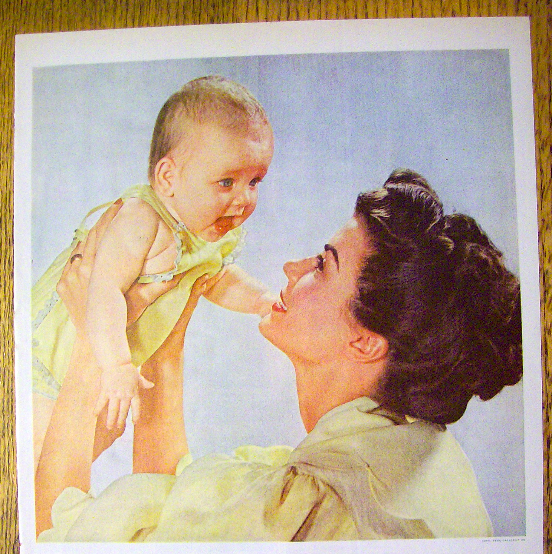 1955 Carnation Milk with Mother Holding Up Baby
