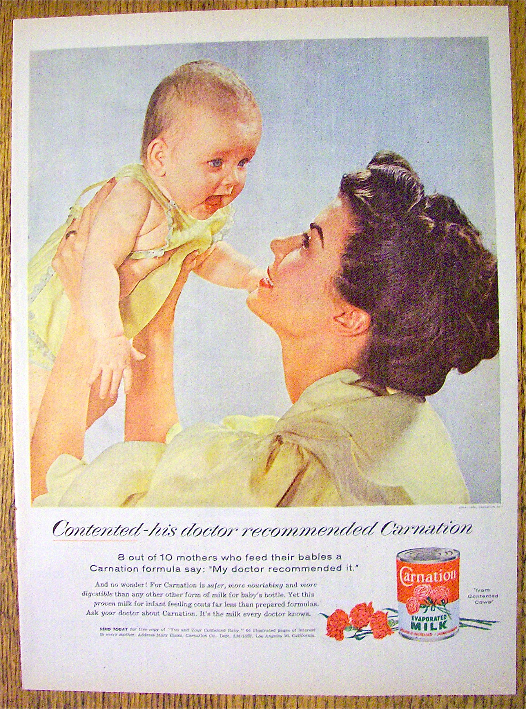 1955 Carnation Milk with Mother Holding Up Baby
