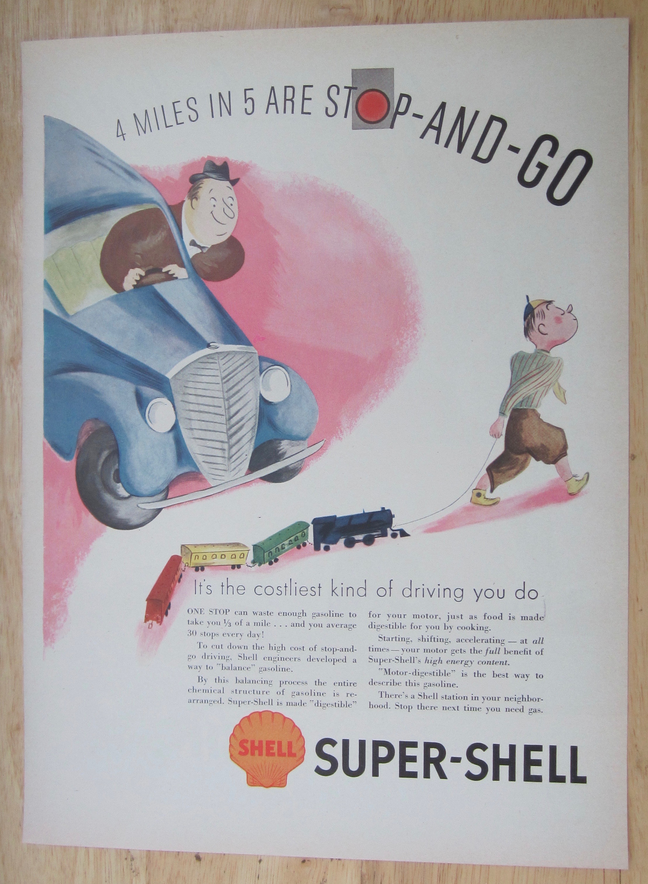 1937 Super Shell Gas with Boy Pulling Train